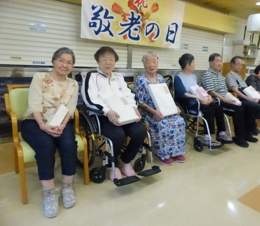 敬老会で長寿祝いを受ける利用者の皆さま