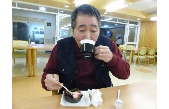 喫茶の日で提供されたケーキとコーヒーを味わう男性利用者様
